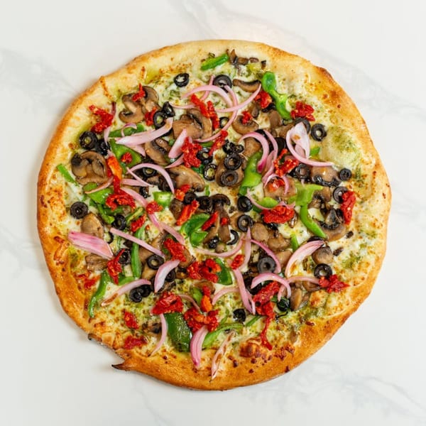 MONDO PIZZA's pesto pizza with mushrooms, olives, green peppers, red onions, and sun-dried tomatoes.
